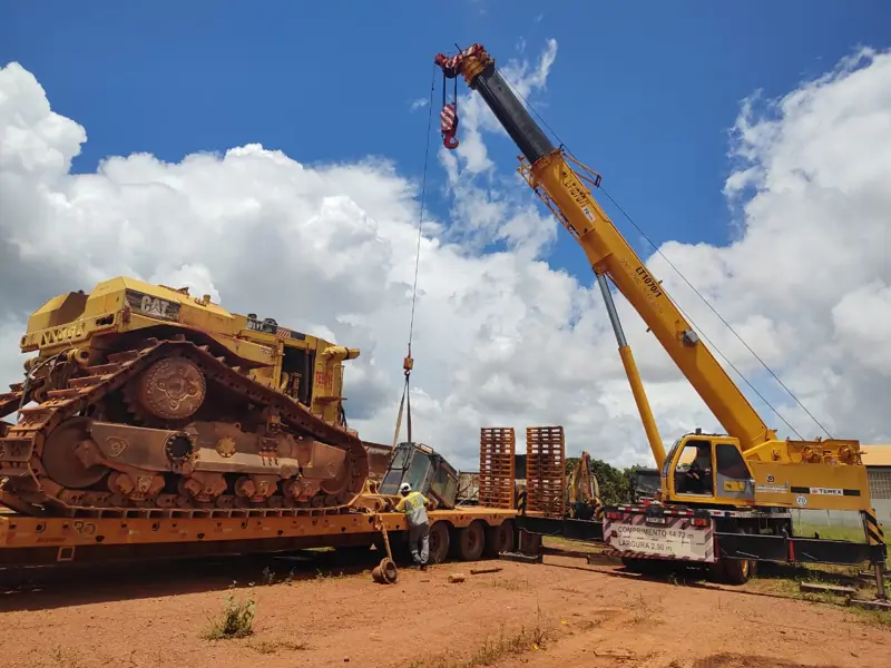 Crane lifting a crawler dozer