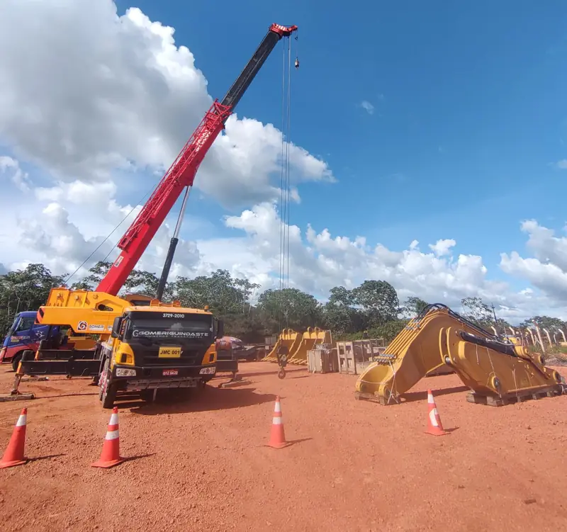 Crane lifting an excavator