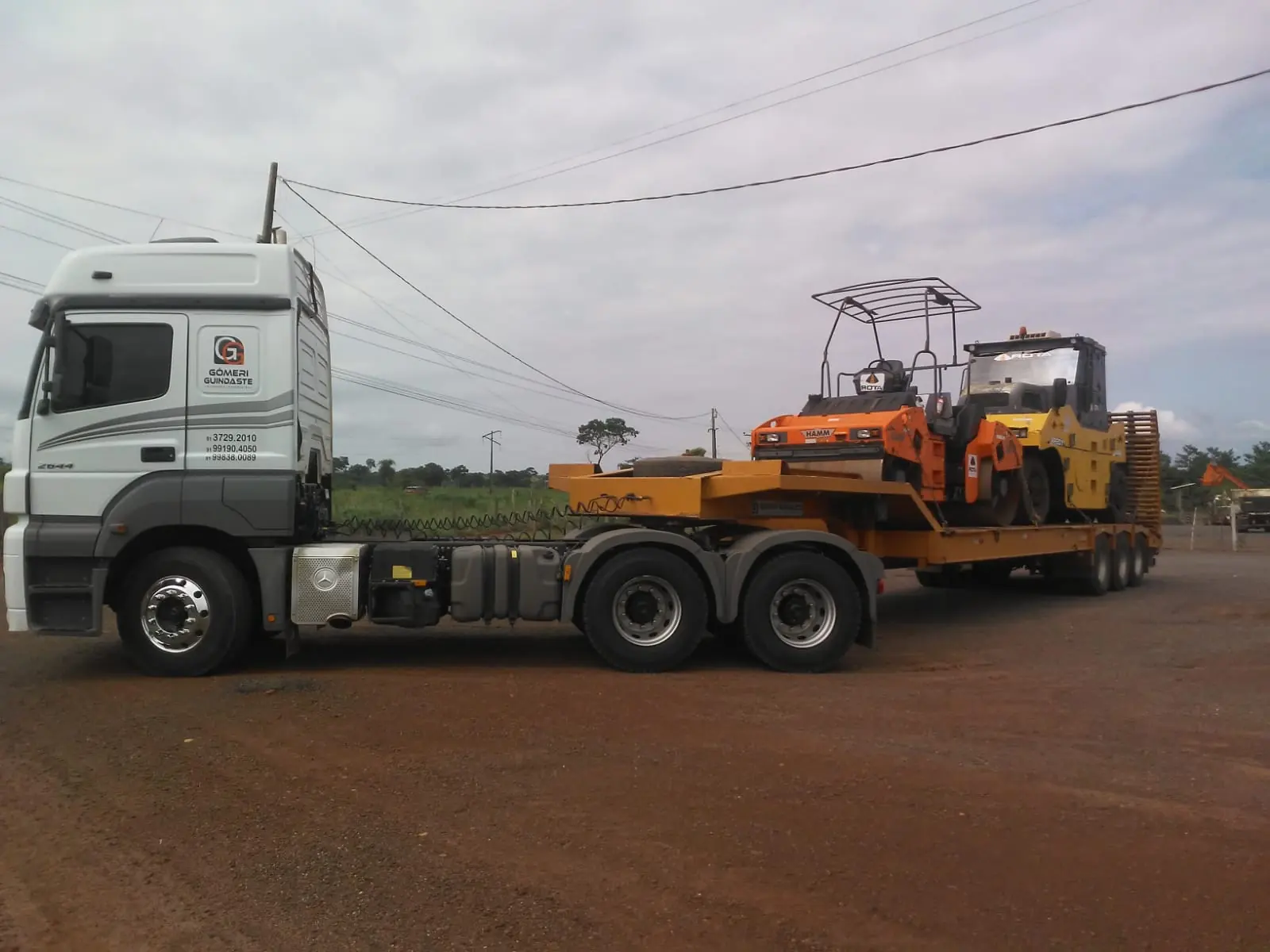 Road roller transported on a lowboy trailer