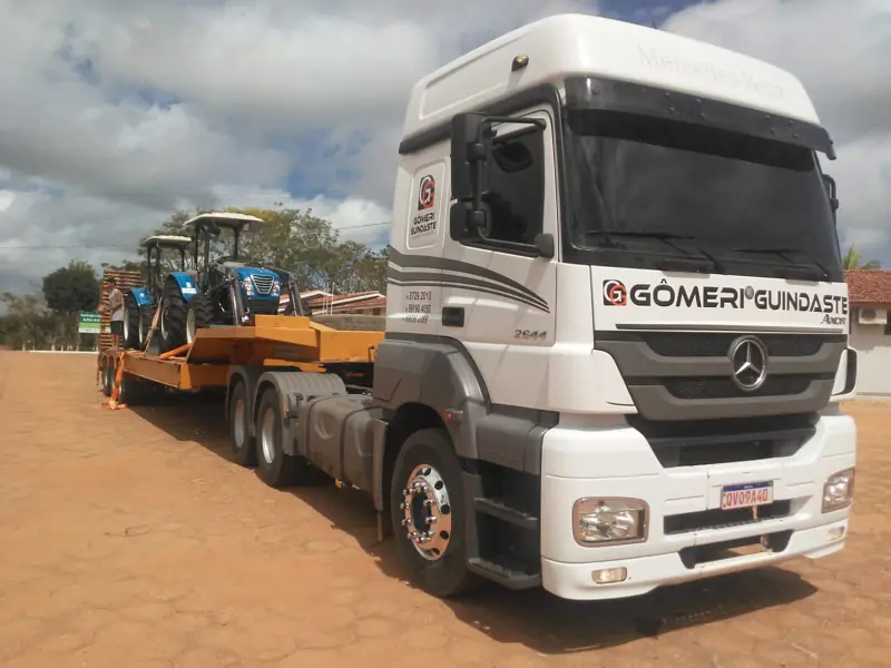 Gomeri truck and lowboy trailer transporting tractors